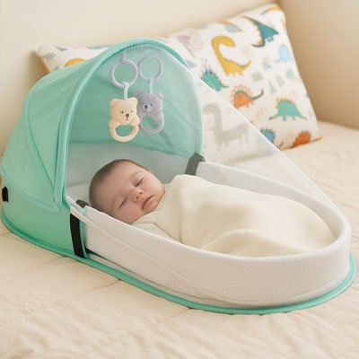 bébé dans lit de bébé voyage vert dans chambre